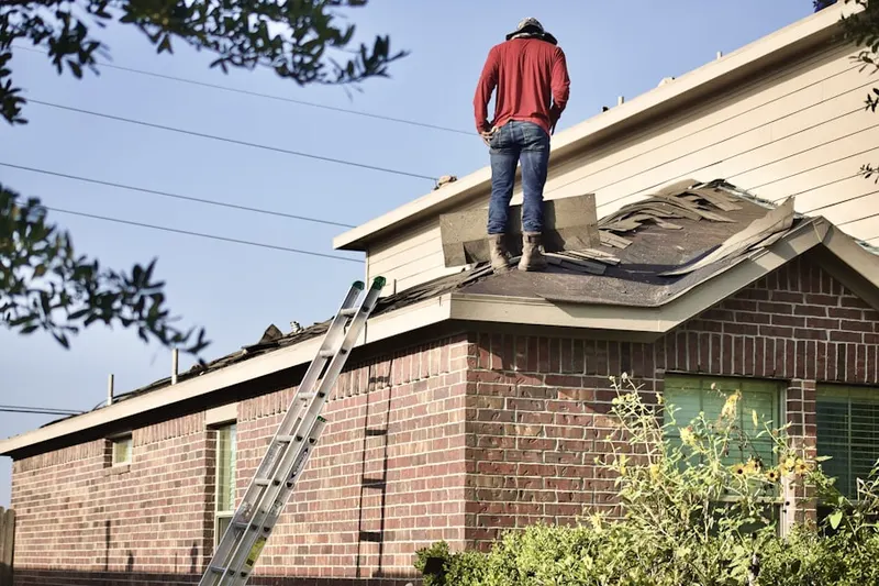 Professional roofer working on a residential roof in Mill Pond Village